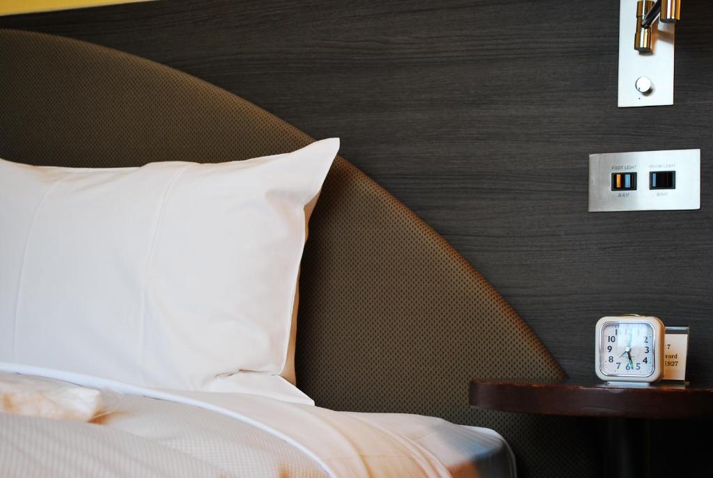 Postel nebo postele na pokoji v ubytování Ginza Grand Hotel