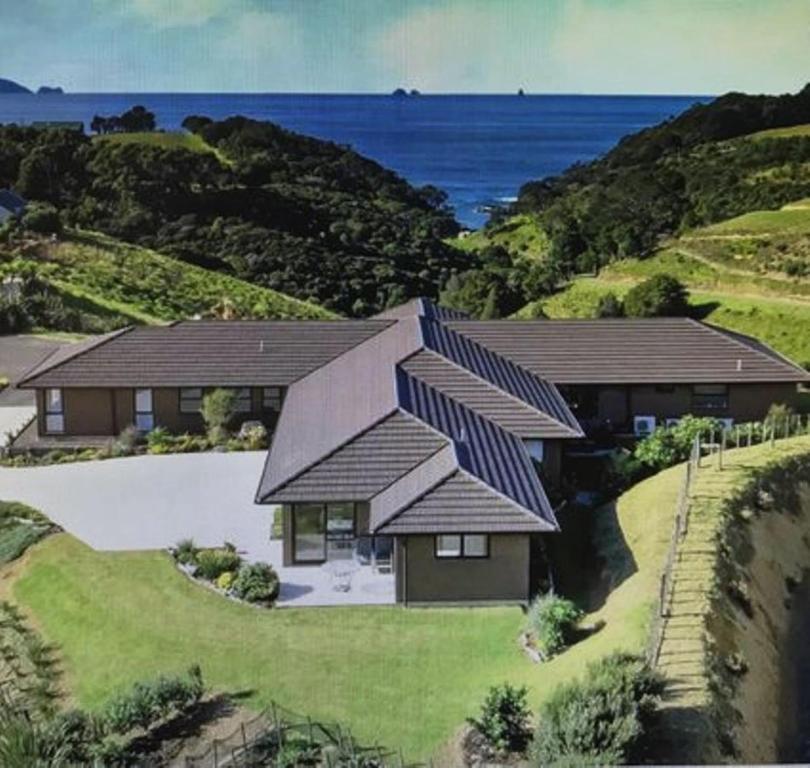 an aerial view of a house with a roof at TuiRidge Tutukaka in Tutukaka