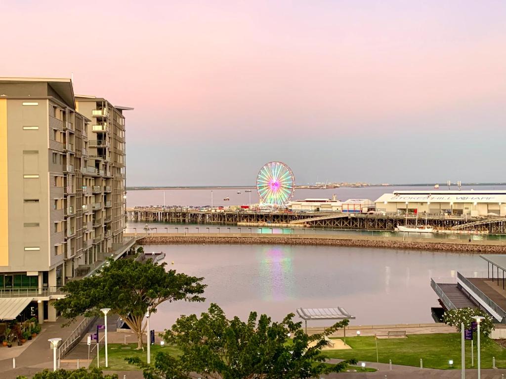 a ferris wheel in the middle of a body of water at Serenity Zealandia - Luxury 1brm unit at Darwin Waterfront in Darwin