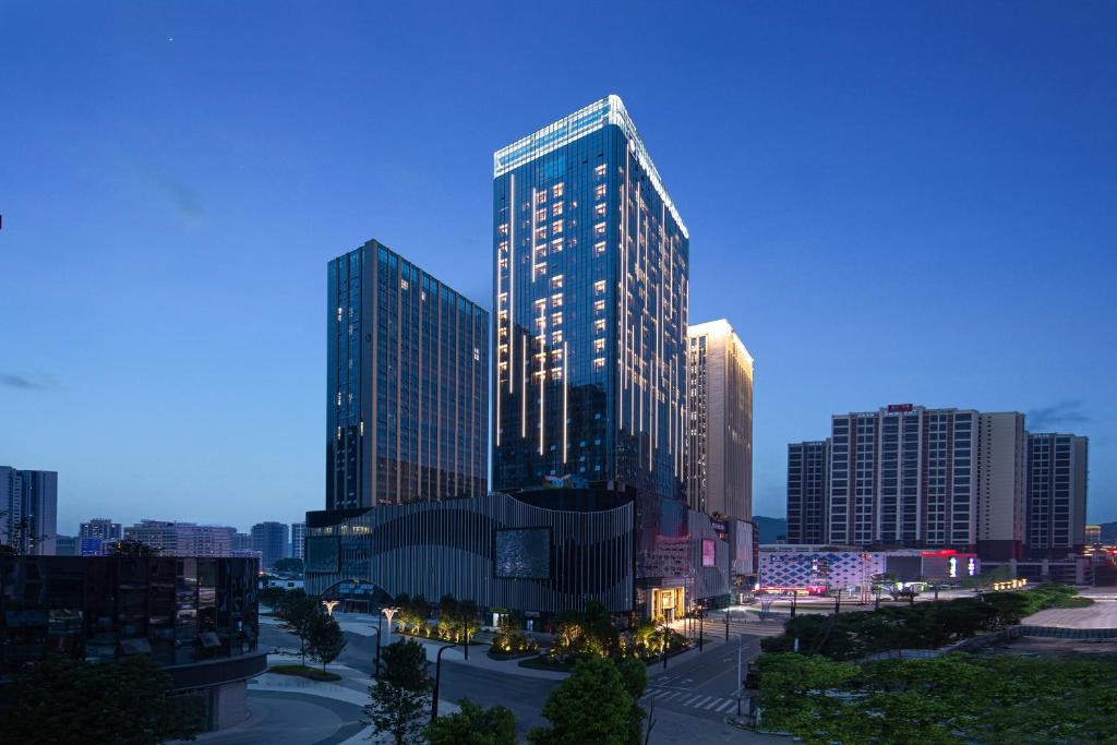 a rendering of a tall building in a city at Wyndham Grand Tongren Downtown Hotel in Tongren