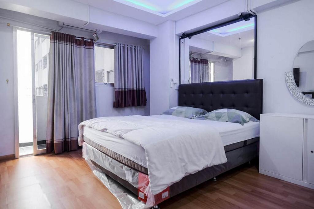 Apartemen Sentra Timur Residence - Fortune 88 Tower Orange tesisinde bir odada yatak veya yataklar