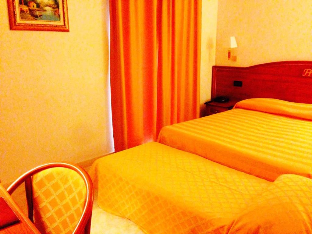 Postel nebo postele na pokoji v ubytování Fashion Hotel