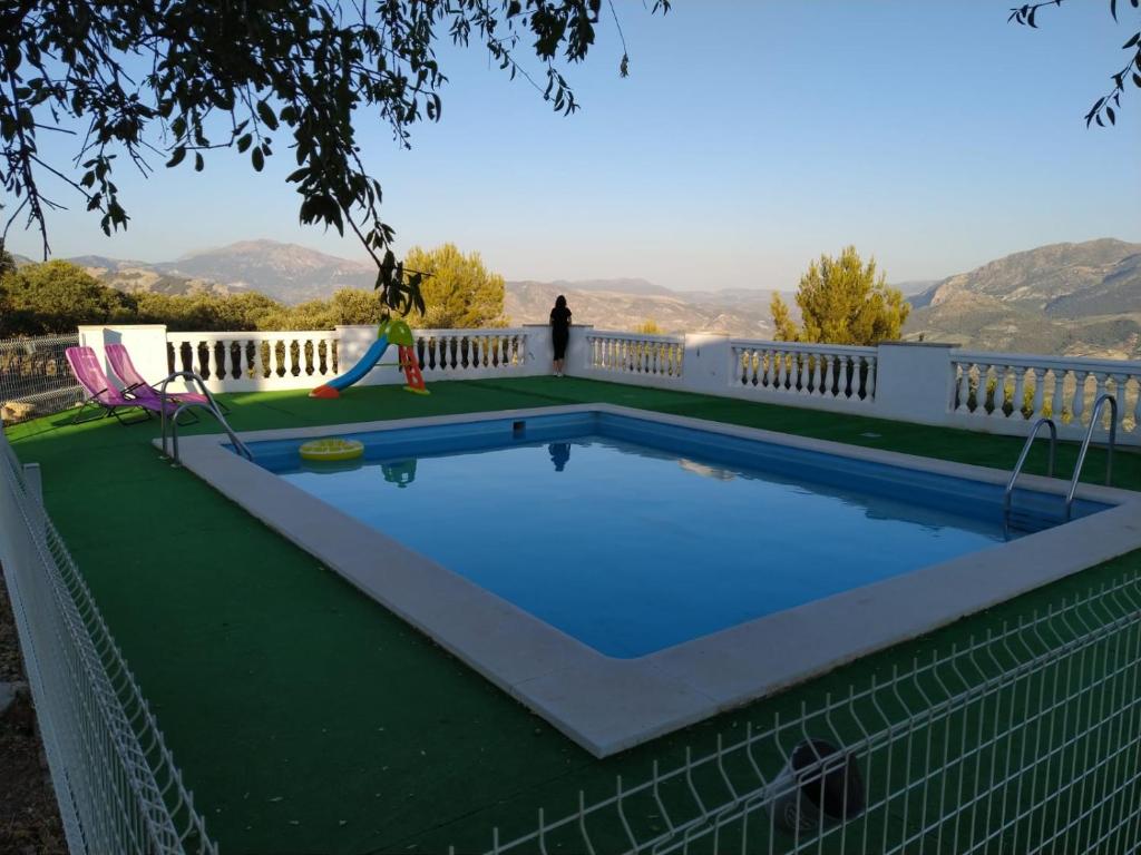 a swimming pool with a slide and a playground at Magina Dream La Guardia Turismo Rural in La Guardia de Jaén