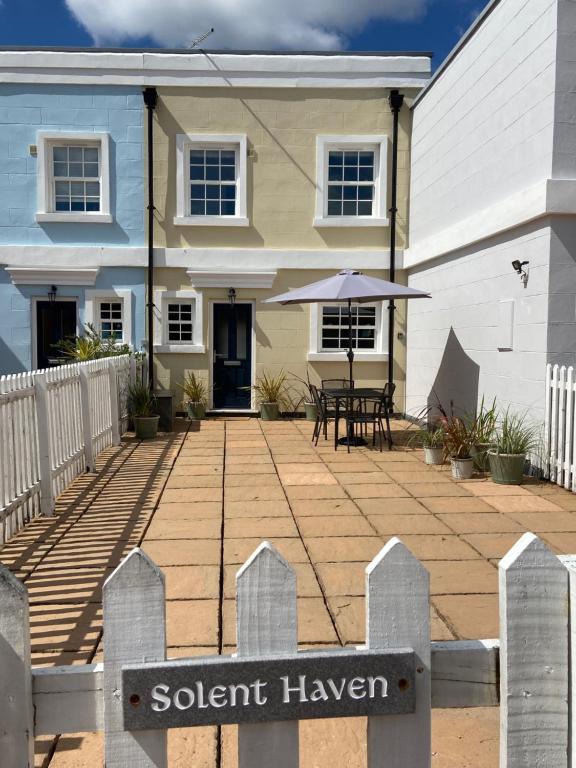 a house with a porch and a sign in front of it at Solent Haven, Lymington with sea views and parking in Lymington