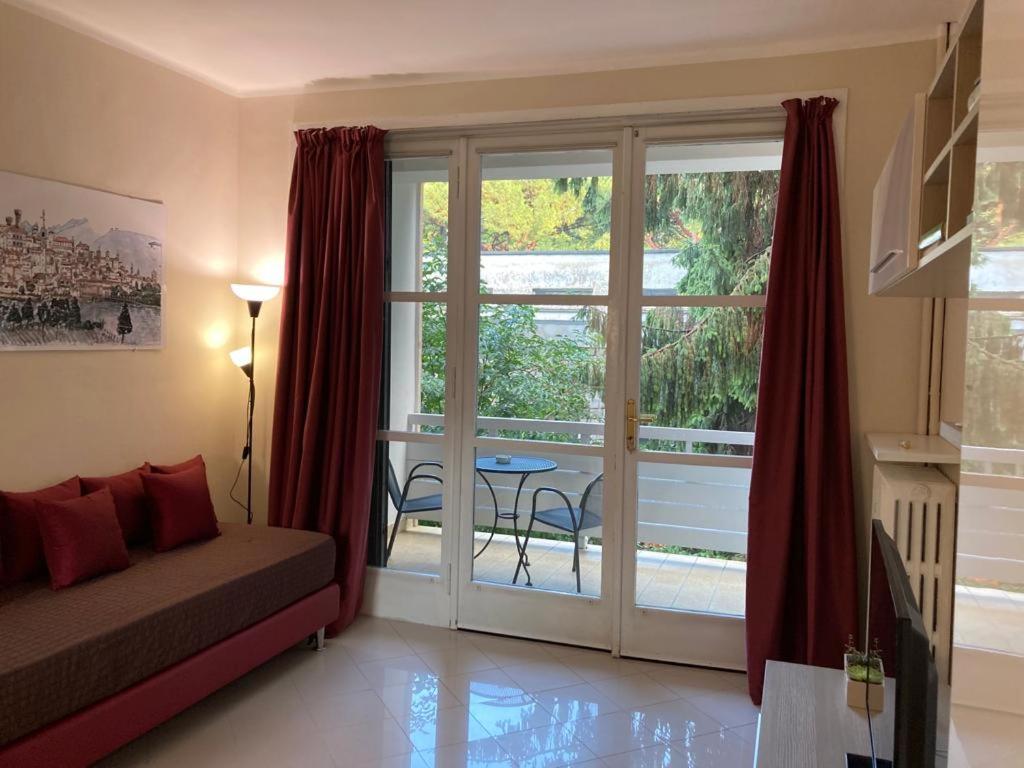 a bedroom with a bed and a sliding glass door at Apartment "Borgo Olivetti" in Ivrea