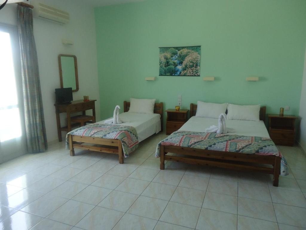 Ένα ή περισσότερα κρεβάτια σε δωμάτιο στο Saloustros Apartments