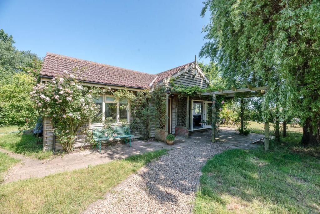 a small house with a garden in front of it at Ferry Corner Cottage, Sudbourne in Woodbridge
