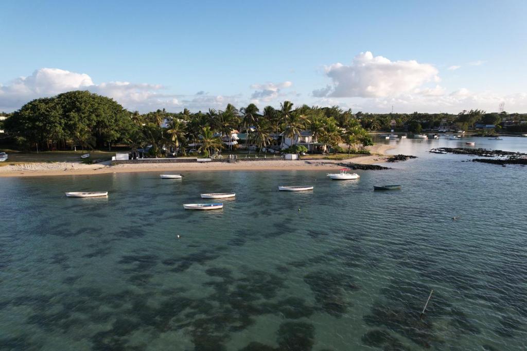 a group of boats in the water near a beach at Islands View - Mazor Beach Villas in Grand Gaube