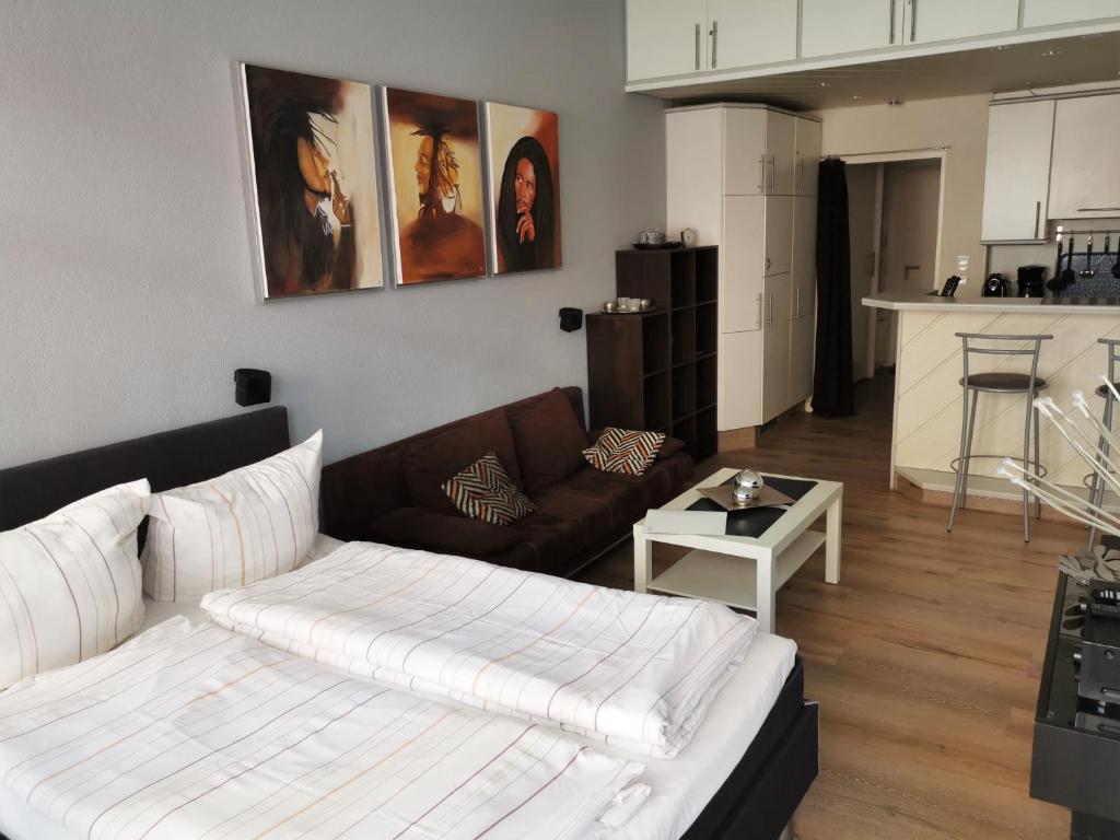 a living room with a bed and a couch at Alte Teestube Alte Teestube 57 in Norderney