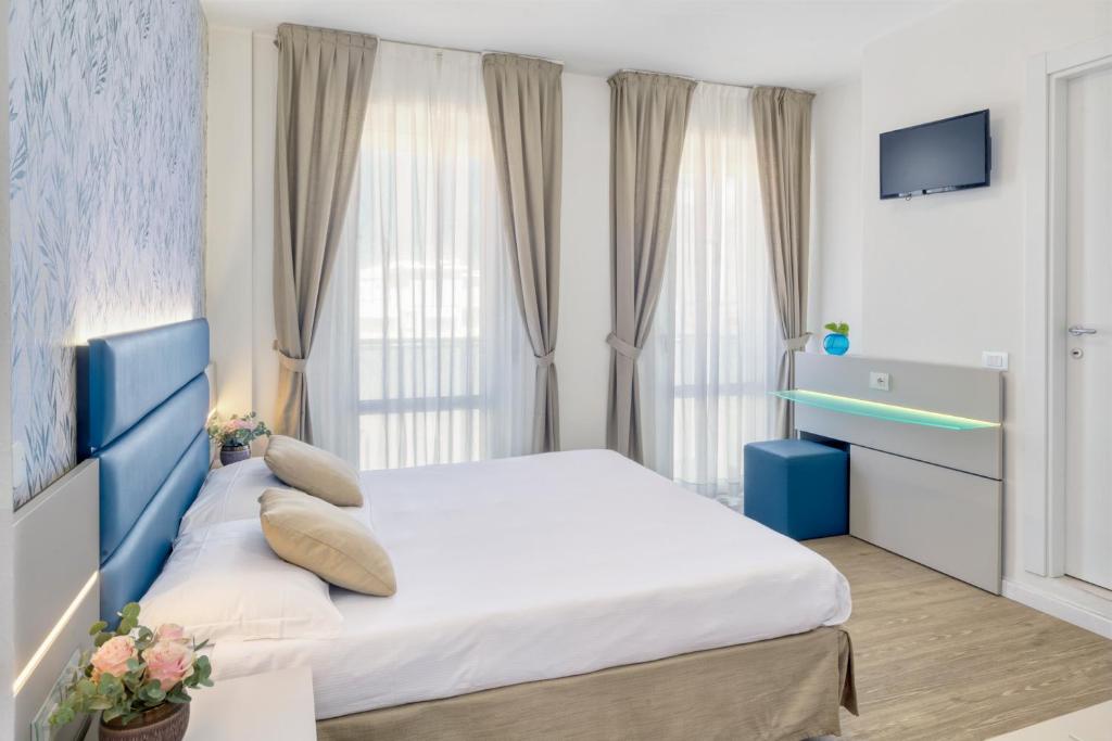 Postel nebo postele na pokoji v ubytování Hotel Astoria