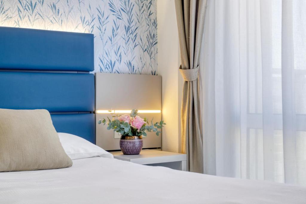 Postel nebo postele na pokoji v ubytování Hotel Astoria