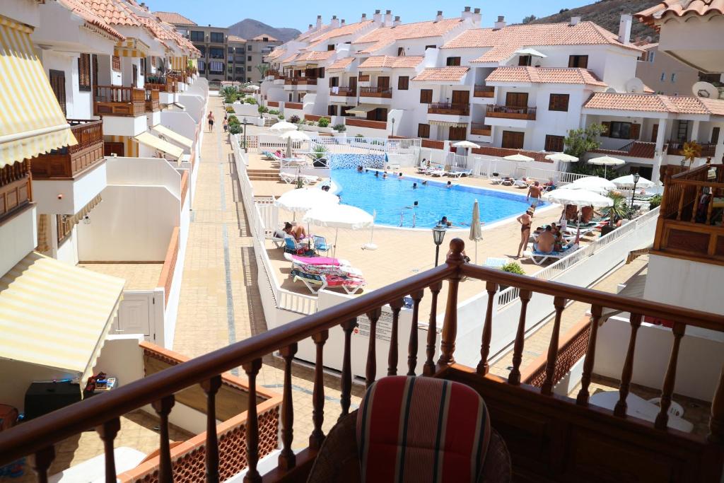 a view of the pool from the balcony of a hotel at Mar Holiday Home in Los Cristianos