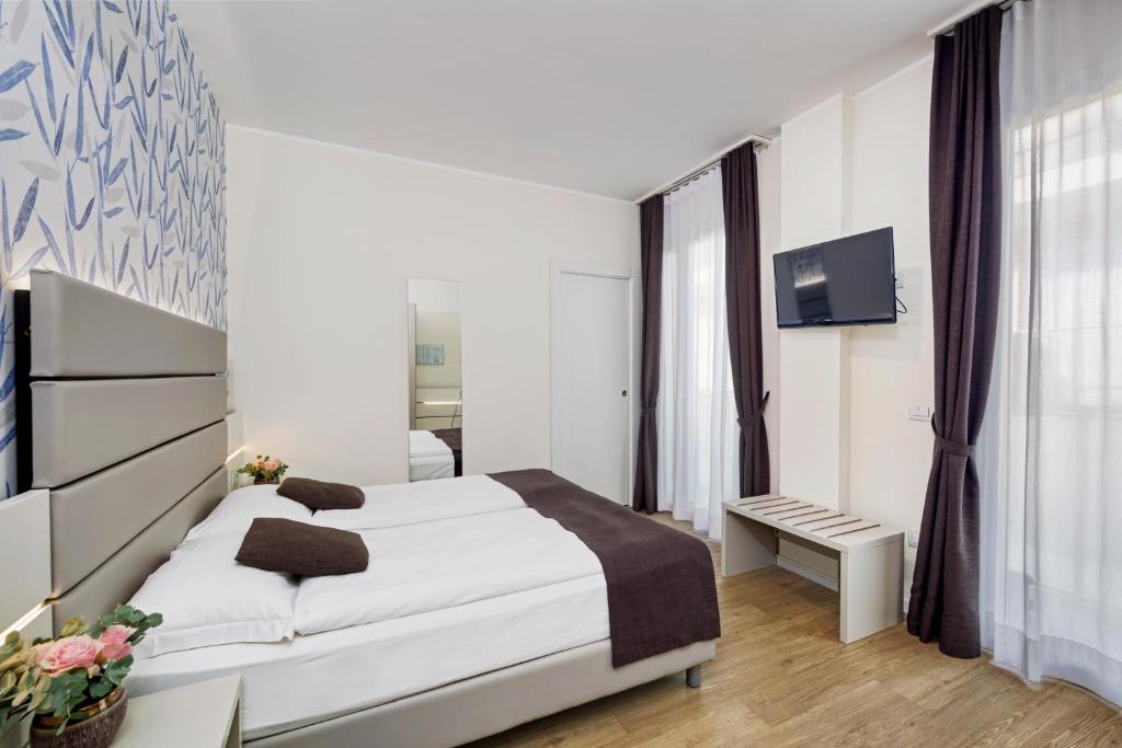 Postel nebo postele na pokoji v ubytování Hotel Astoria