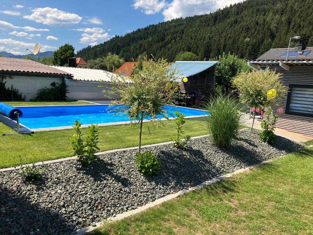 a garden with a swimming pool and a house at Gleinstraße 24 Wohnung in Sankt Margarethen bei Knittelfeld