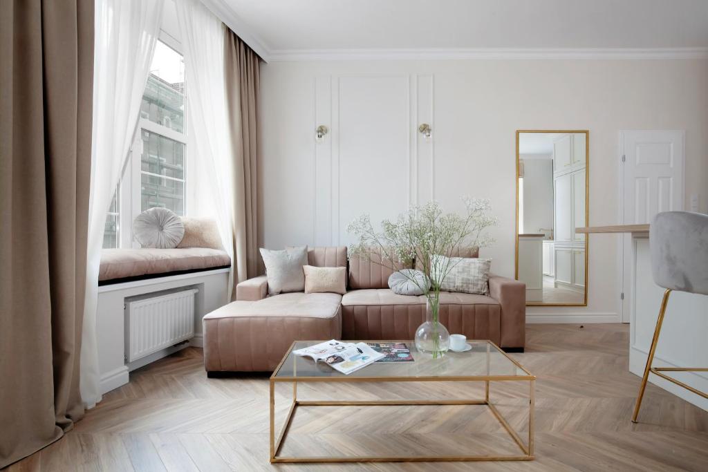 a living room with a couch and a coffee table at Elite Apartments Piwna Prestige in Gdańsk