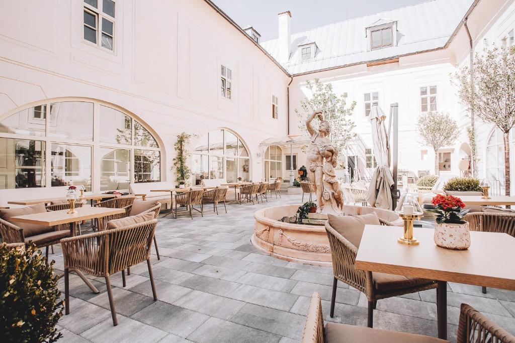 a restaurant with tables and chairs and a fountain at Apartmán Opera Prosecco Bar in Banská Štiavnica