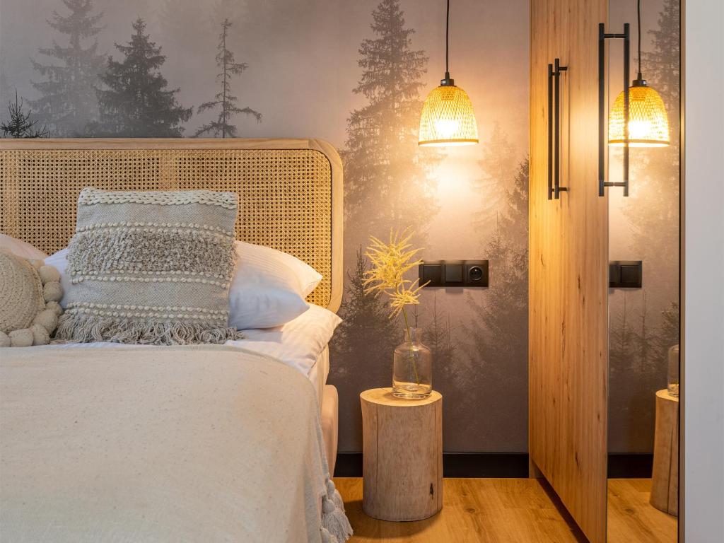 een slaapkamer met een bed met witte kussens bij Apartamenty Klemensówka in Zakopane