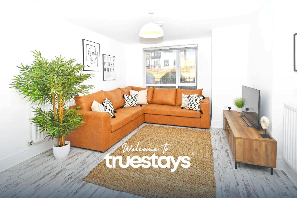 EtruriaにあるIvory House by Truestays - 3 Bedroom House in Stoke-on-Trentのリビングルーム(オレンジ色のソファ、テーブル付)