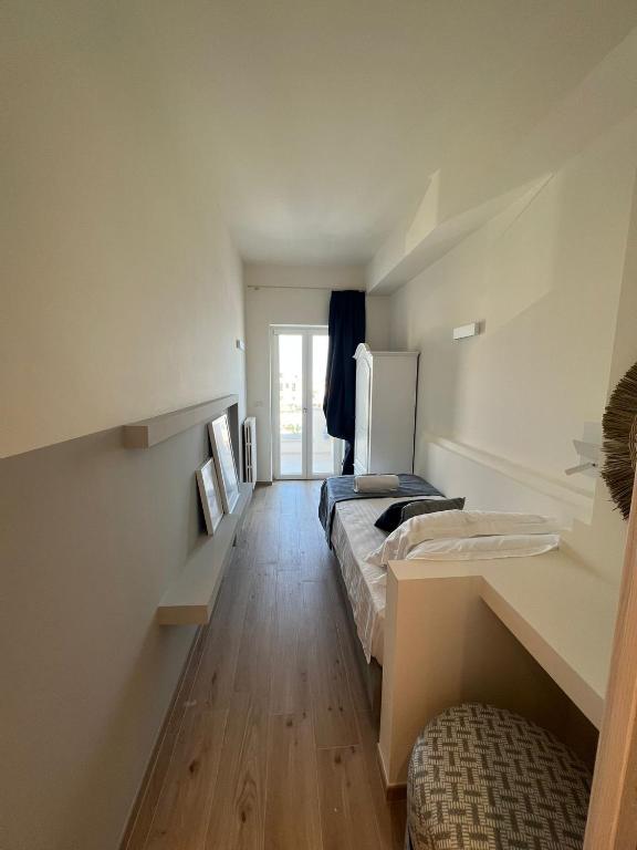 Postel nebo postele na pokoji v ubytování Appartamenti Savelletri Via del Porto
