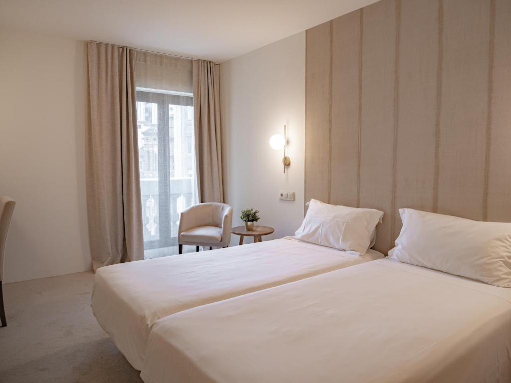 Ένα ή περισσότερα κρεβάτια σε δωμάτιο στο Hotel Oriente