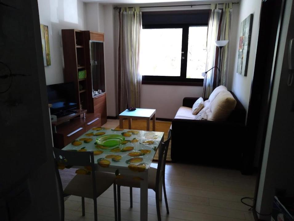 a living room with a table and a couch at Loft BAINIS Peregrinos & Uso Turístico in A Guarda