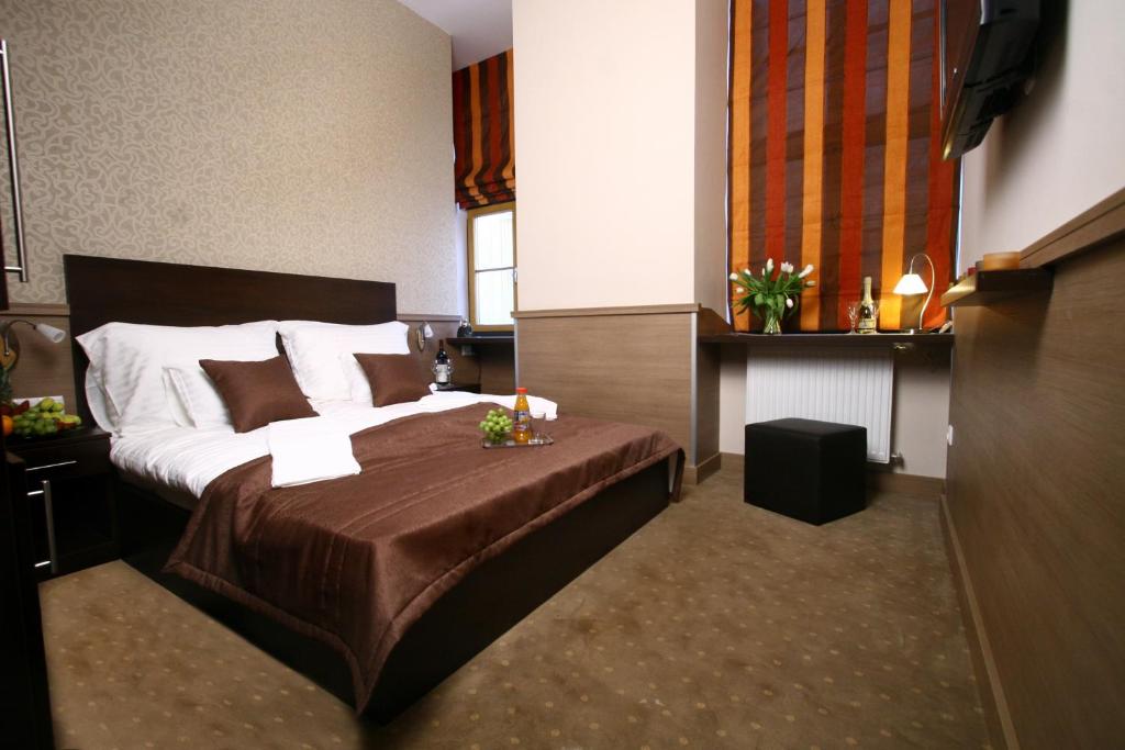 Postel nebo postele na pokoji v ubytování Central Hotel 21 and Apartments