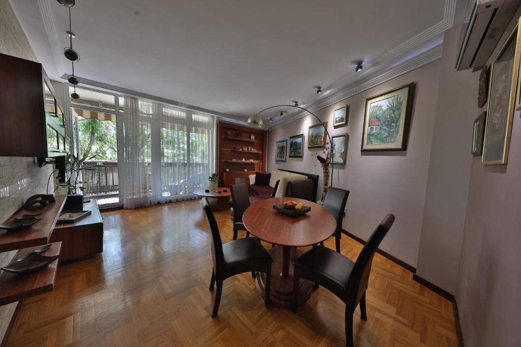 a dining room and living room with a table and chairs at Luxurious apartment in Belgrade in Belgrade
