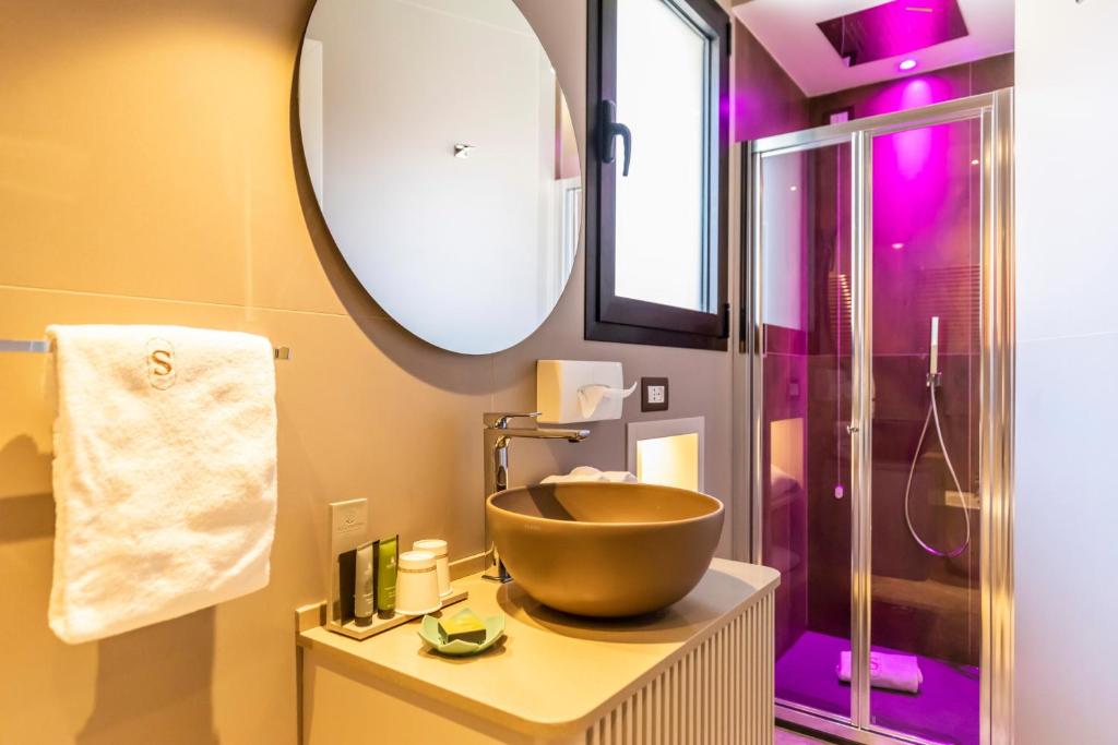 a bathroom with a bowl sink and a shower at Solmaris Tropea Rooms & Suites in Tropea