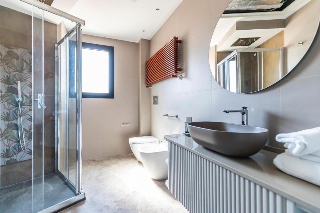 a bathroom with a sink and a mirror at Solmaris Tropea Rooms & Suites in Tropea