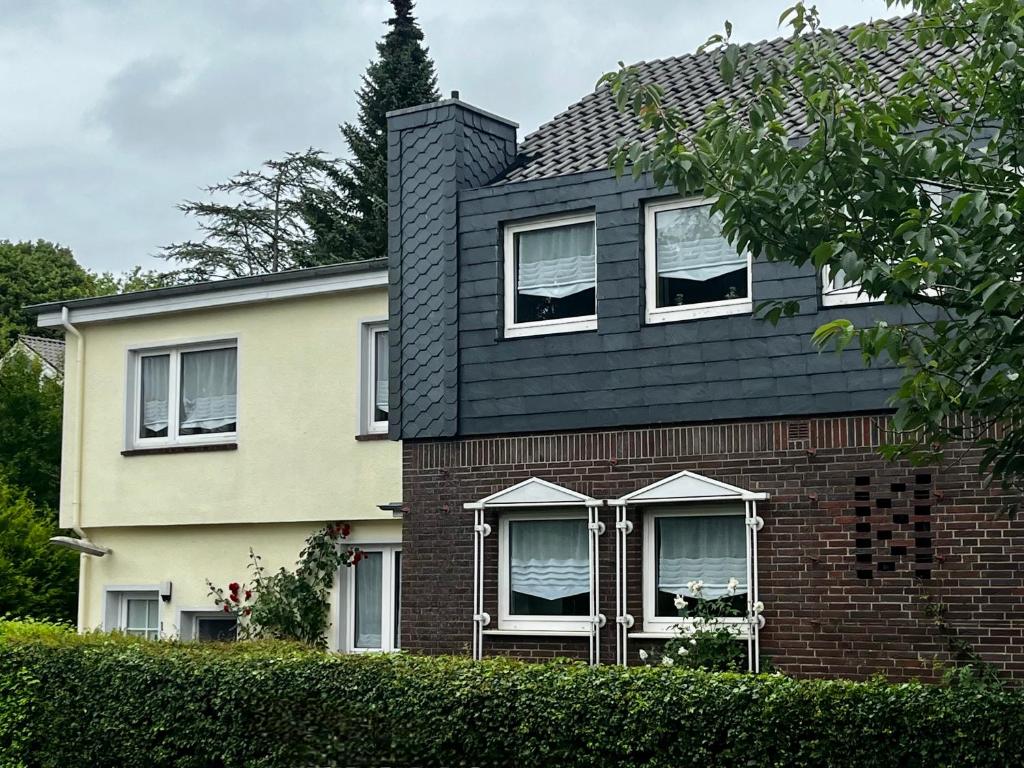 a brick house with a black roof at Gästehaus 2 Norden in Norden