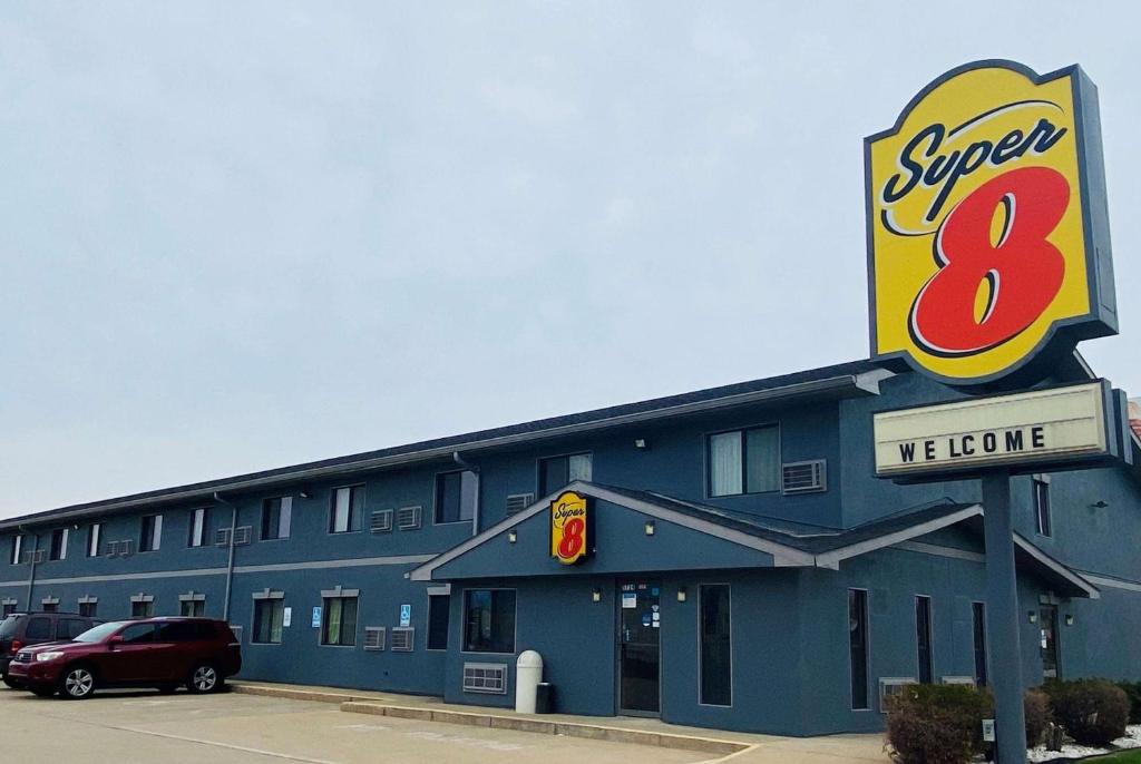 a large blue building with a sign that reads super at Super 8 by Wyndham Michigan City in Michigan City