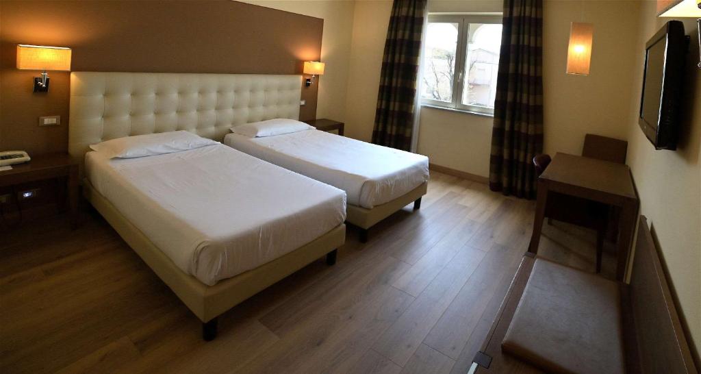 Postel nebo postele na pokoji v ubytování Best Western Grand Hotel Guinigi