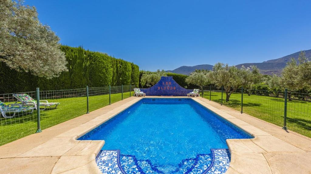 a swimming pool in a yard with a slide at Casa Los Olivos Orgiva by Ruralidays in Órgiva