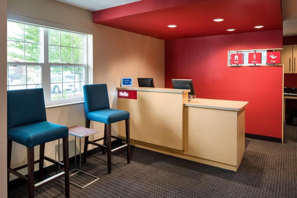 a waiting room with two chairs and a counter at Sonesta Simply Suites Seattle Renton in Renton