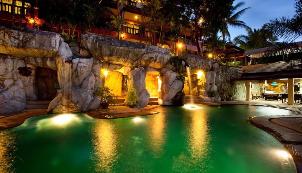 ein Schwimmbad in einem Resort in der Nacht in der Unterkunft C & N Resort and Spa - SHA Extra Plus in Patong Beach
