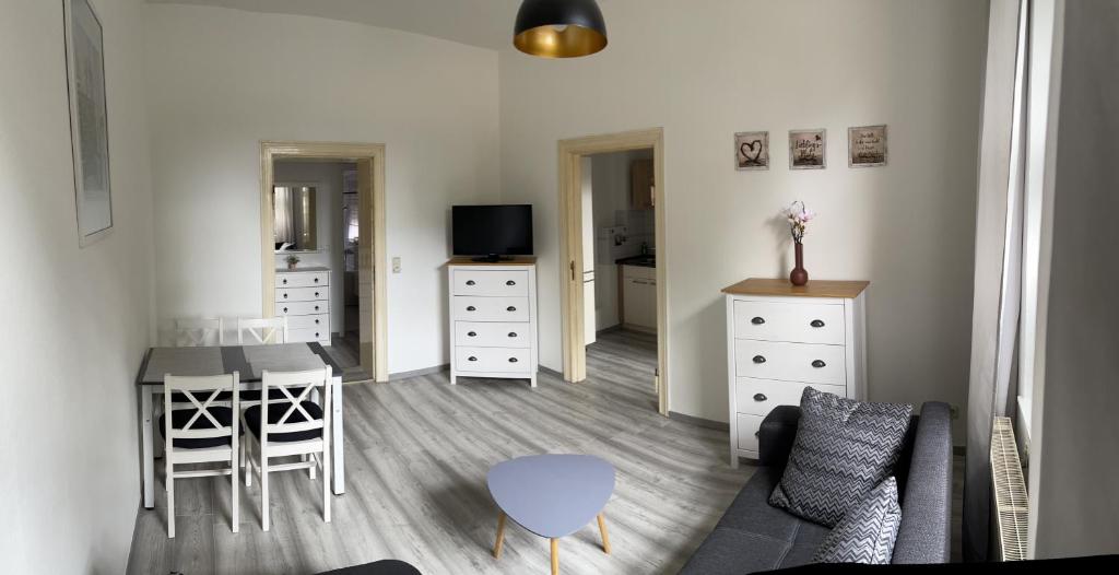 a living room with a table and a dining room at Fewo Rico 3 in Quedlinburg