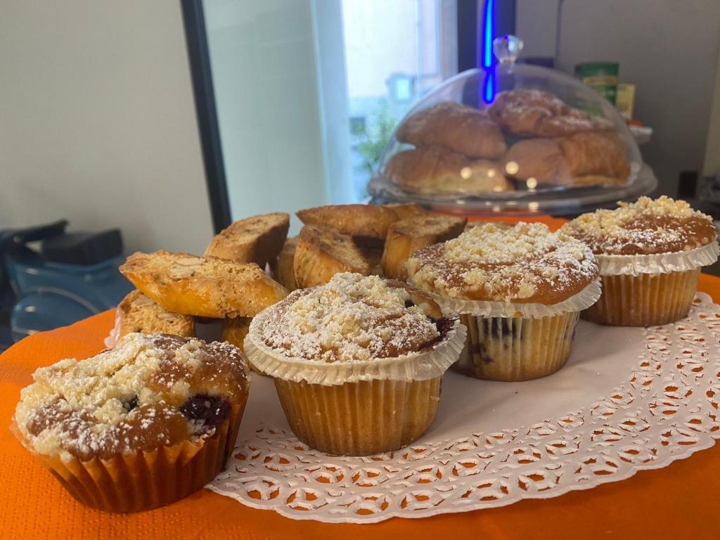 a bunch of muffins and other pastries on a table at Solmaris Tropea Rooms & Suites in Tropea