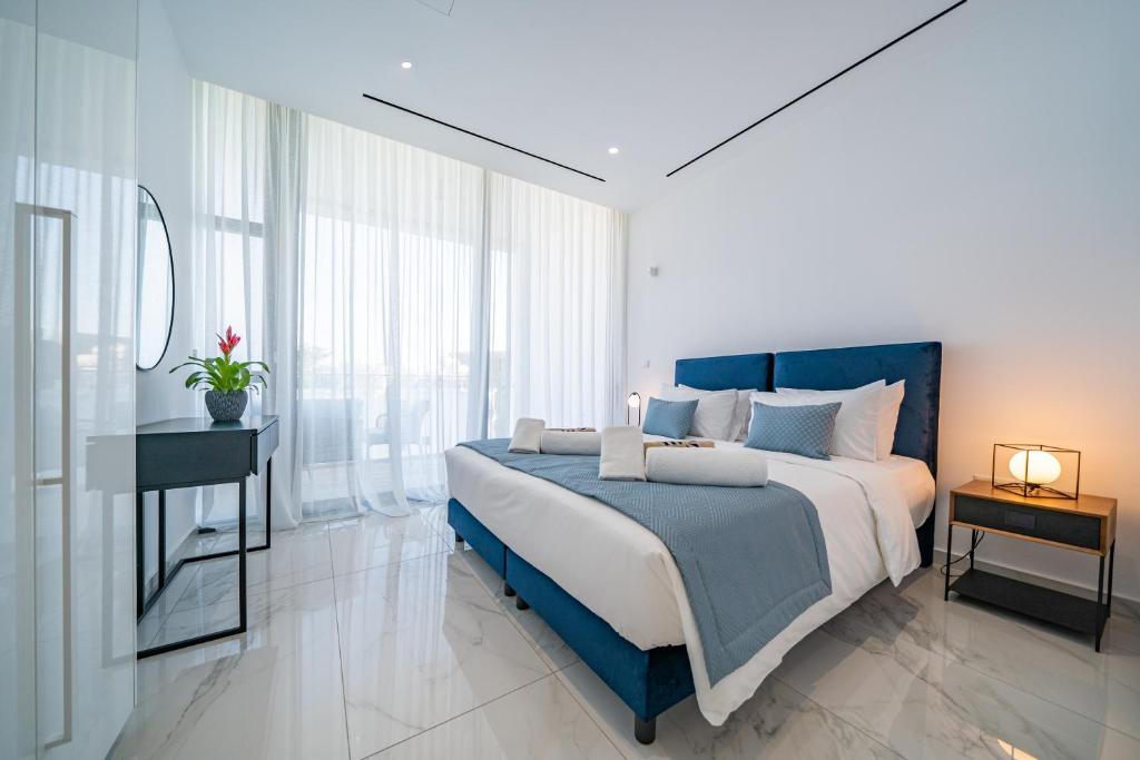 a bedroom with a bed and a table and a mirror at The Palmiers in Paphos City