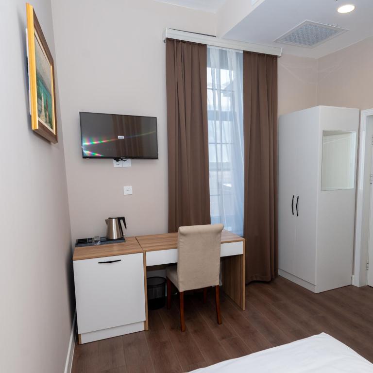 TV a/nebo společenská místnost v ubytování OLF Hotel