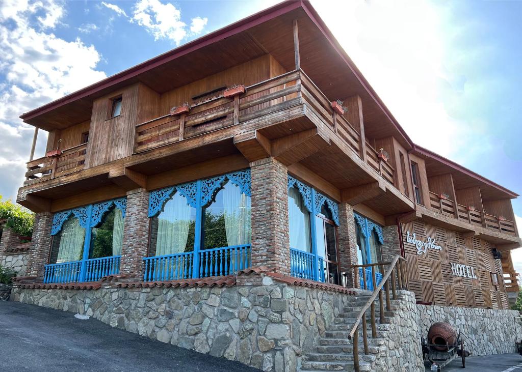 a house with a balcony on the side of it at Hillside Resort Telavi in Telavi