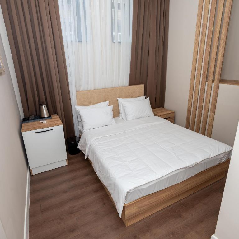 Postel nebo postele na pokoji v ubytování OLF Hotel