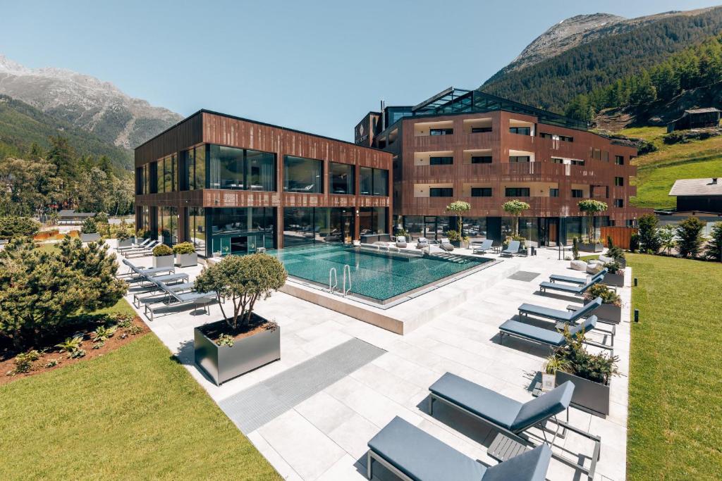 a resort with a swimming pool and a building at The Secret Sölden in Sölden
