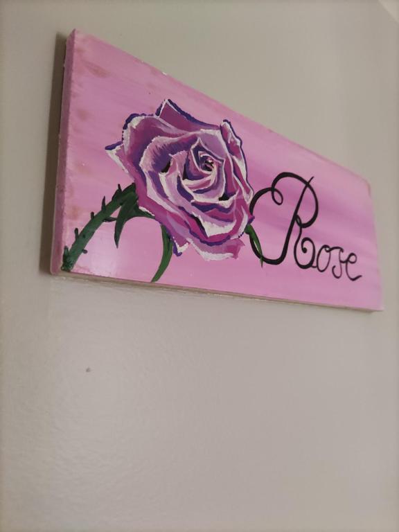 a painting of a rose with the word force at Le Nid - Studios in Chartres