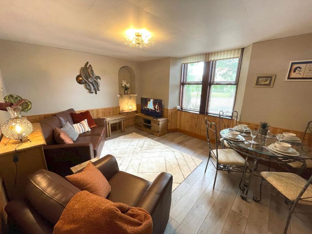 a living room with a couch and a table at Pass the Keys Beautiful Apartment - Outstanding Central Location in Dumfries