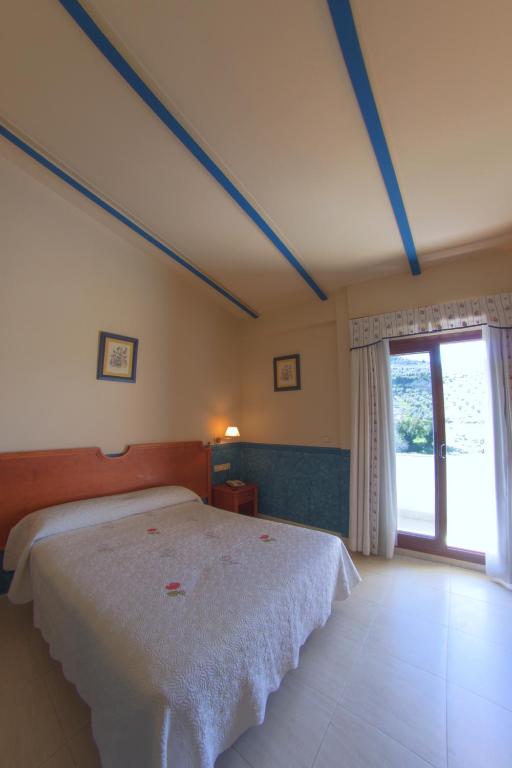 Postel nebo postele na pokoji v ubytování Hotel Avenida