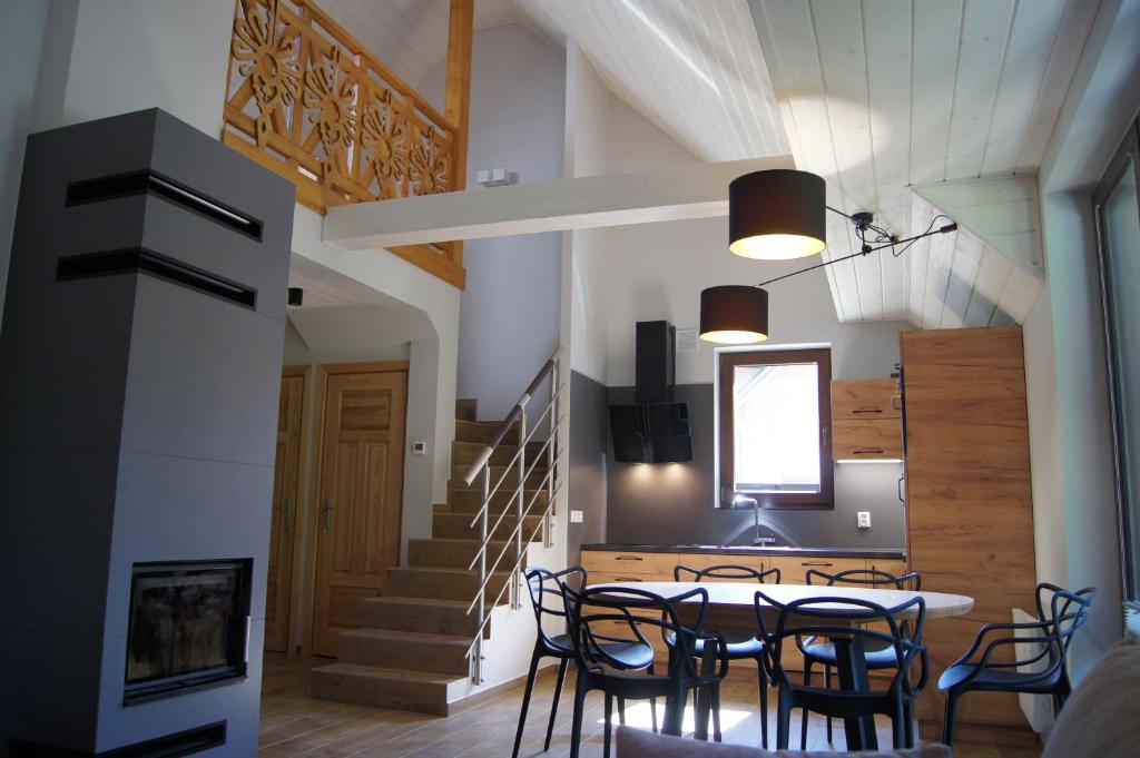 a kitchen and dining room with a table and chairs at Apartament Zacisze in Jaworki