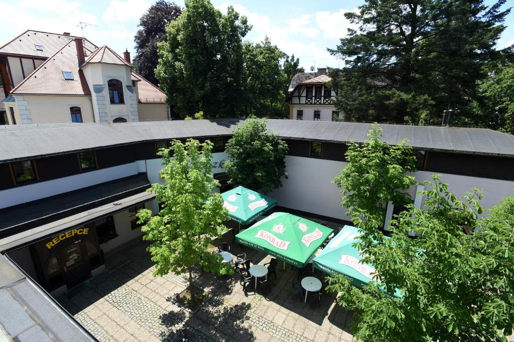 an overhead view of a patio with tables and trees at Hotel U Jezírka in Liberec
