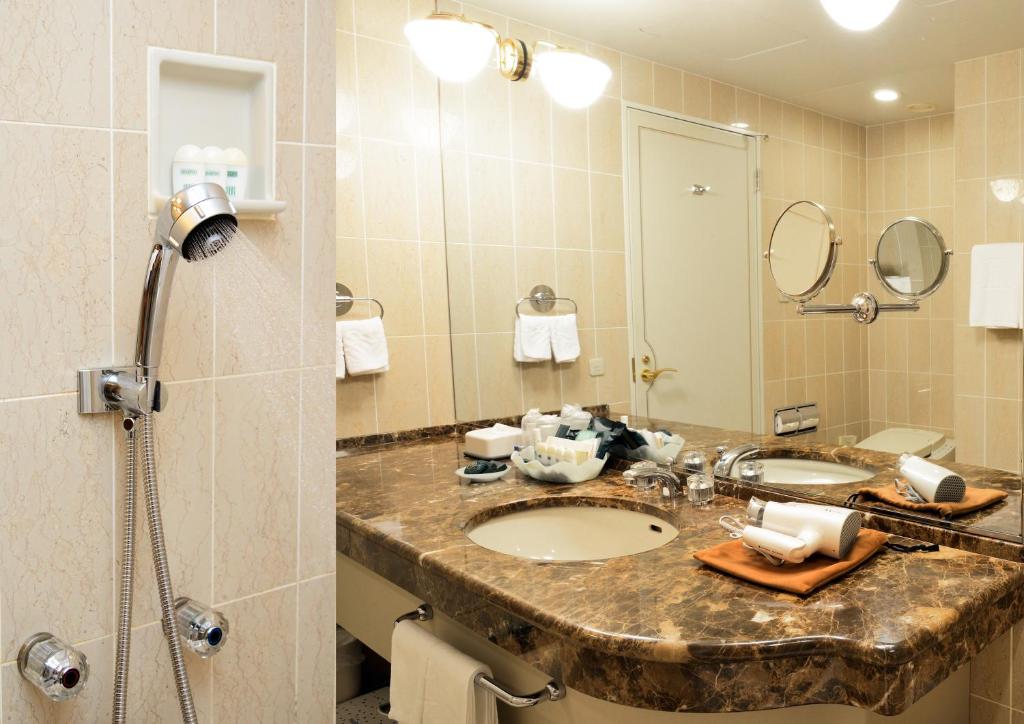 a bathroom with a sink and a mirror at Rihga Royal Hotel Hiroshima in Hiroshima