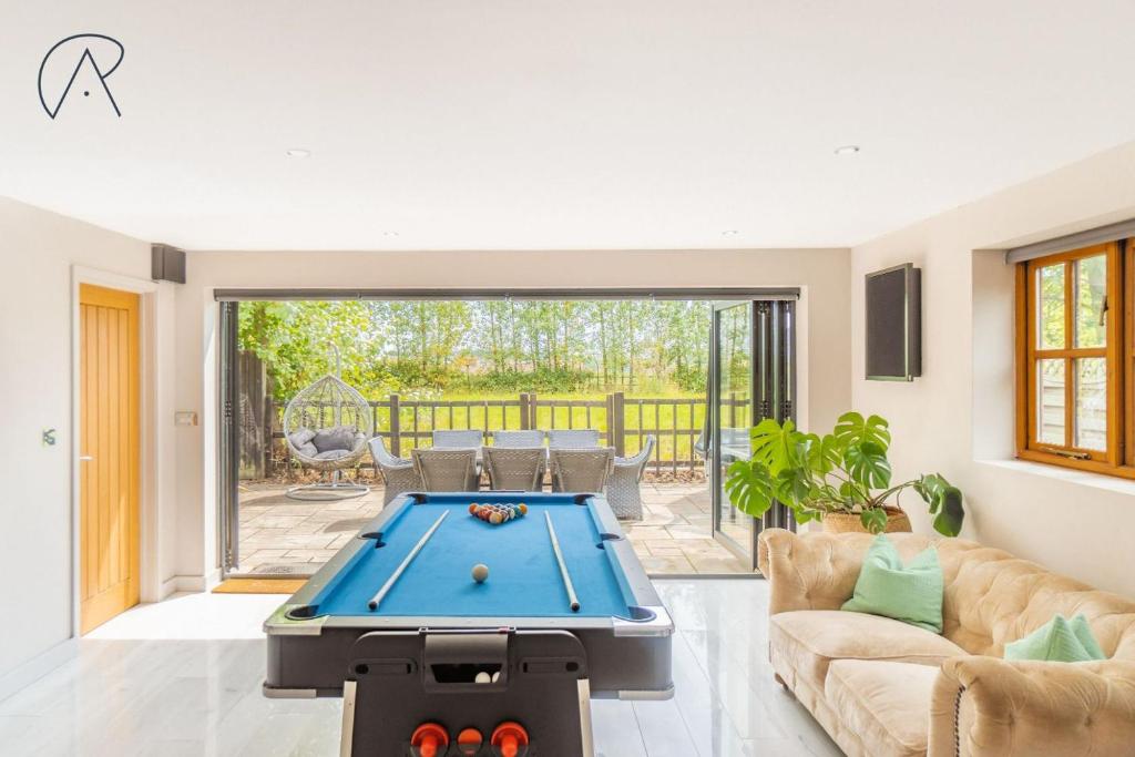 a living room with a pool table in it at Dorney Barn, Close To Windsor Legoland in Dorney