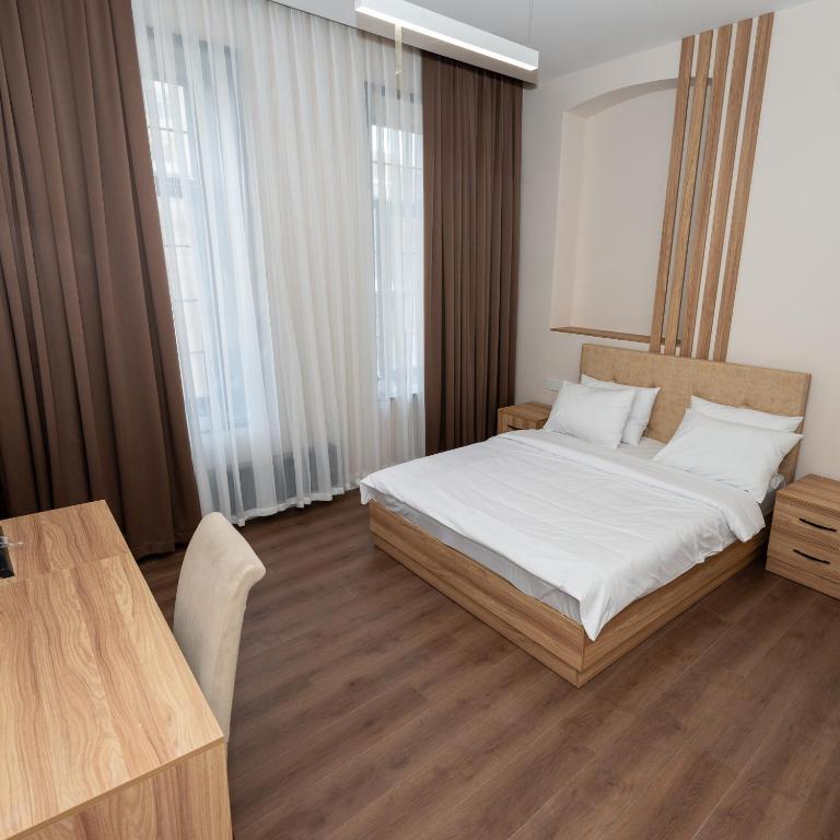 Postel nebo postele na pokoji v ubytování OLF Hotel